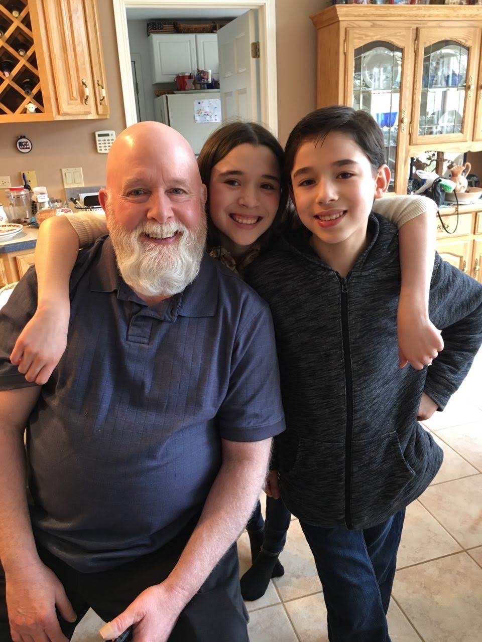 Tom with grandchildren in the kitchen